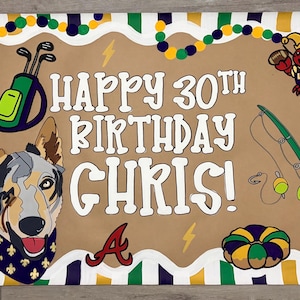 May include: A rectangular birthday banner with a tan center featuring the text HAPPY 30TH BIRTHDAY CHRIS! in white. Graphics include a dog with a blue bandana, a golf bag, a fishing rod, a crawfish, a king cake, and a fleur-de-lis on a striped border.