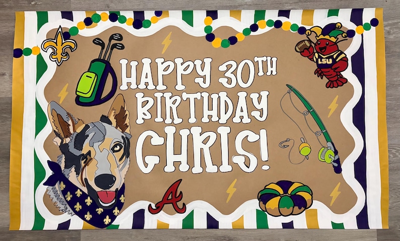 May include: A rectangular birthday banner with a tan center featuring the text HAPPY 30TH BIRTHDAY CHRIS! in white. Graphics include a dog with a blue bandana, a golf bag, a fishing rod, a crawfish, a king cake, and a fleur-de-lis on a striped border.