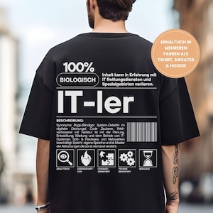 Può includere: T-shirt nero oversize con testo e grafica bianchi. La maglietta presenta le parole "100% BIOLOGISCH" e "IT-ler" in grandi lettere bianche. Ulteriori testo e icone sono stampati in basso. La maglietta è disponibile in più colori come t-shirt, felpa e felpa con cappuccio.
