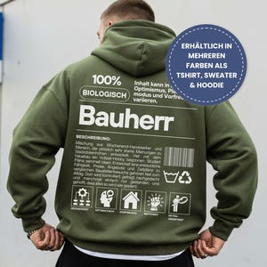 Peut inclure: Un sweat à capuche vert olive avec du texte et des graphiques blancs au dos. Le texte comprend "100% BIOLOGISCH" et "Bauherr". Un graphique circulaire bleu indique "DISPONIBLE EN PLUSIEURS COULEURS COMME TSHIRT, SWEAT & HOODIE".