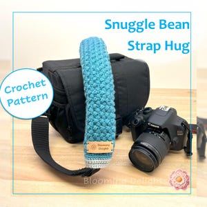 May include: A blue and gray crochet strap hug, labeled "Snuggle Bean Strap Hug," rests on a black camera bag. The text "Crochet Pattern" is in a circle. A Canon EOS 1200D camera is also visible.