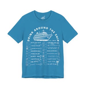 May include: A light blue t-shirt with a white graphic of a cruise ship and the text "Drink Around The Ship". The graphic also includes a list of bars on the ship, such as "Wipe Out Bar", "Schooner Bar", "English Pub", and "On Air Club".