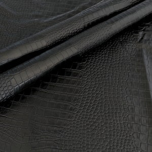 May include: Black faux leather fabric with a crocodile embossed pattern.