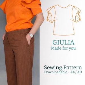 May include: An orange top with layered ruffle sleeves and brown pinstripe pants. The image also includes a sewing pattern with the name "GIULIA" and the text "Made for you". The pattern is downloadable.