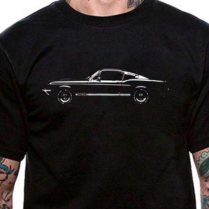 May include: A black t-shirt featuring a white outline of a classic car, a Ford Mustang, on the front.