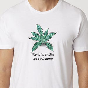 May include: White t-shirt with a green cartoon plant and the text "about as subtle as a nimroot".