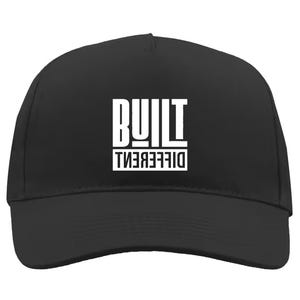 May include: Black baseball cap with a curved peak. The front displays the white text "BUILT" above "DIFFERENT" in a bold, sans-serif font. A classic, casual hat.