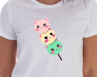 May include: White t-shirt with a graphic of three cartoon cat faces stacked on top of each other on a stick. The cats are pink, yellow, and green.