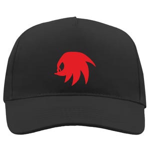 May include: A black baseball cap with a red graphic of a character's head on the front. The cap has a curved peak and a structured crown. This hat is a great accessory for fans of video games and cartoons.