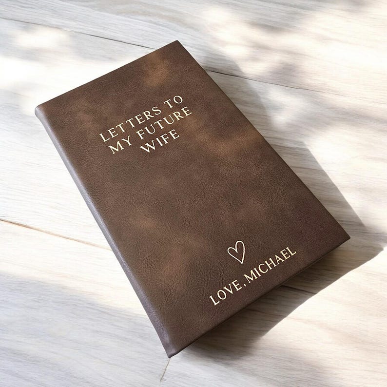 May include: A brown leather-bound journal with the text "Letters to My Future Wife" and "Love, Michael" on the front cover.