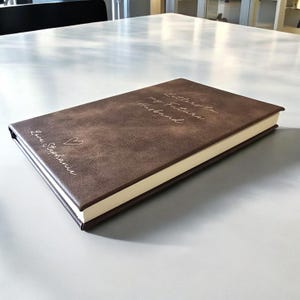 May include: A brown leather-bound journal with the text "Letters to my future husband" and "Love, Stephanie" embossed on the cover.
