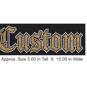 May include: Gold glitter "Custom" text with white rhinestone accents on a black background. Approx. Size 3.00 in Tall X 10.00 in Wide