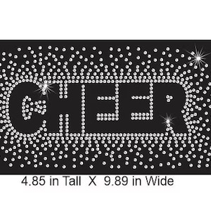 May include: Black rectangular design with the word "CHEER" spelled out in white rhinestones. The word is surrounded by a border of smaller rhinestones. The design is 12.3 cm tall and 25.1 cm wide.