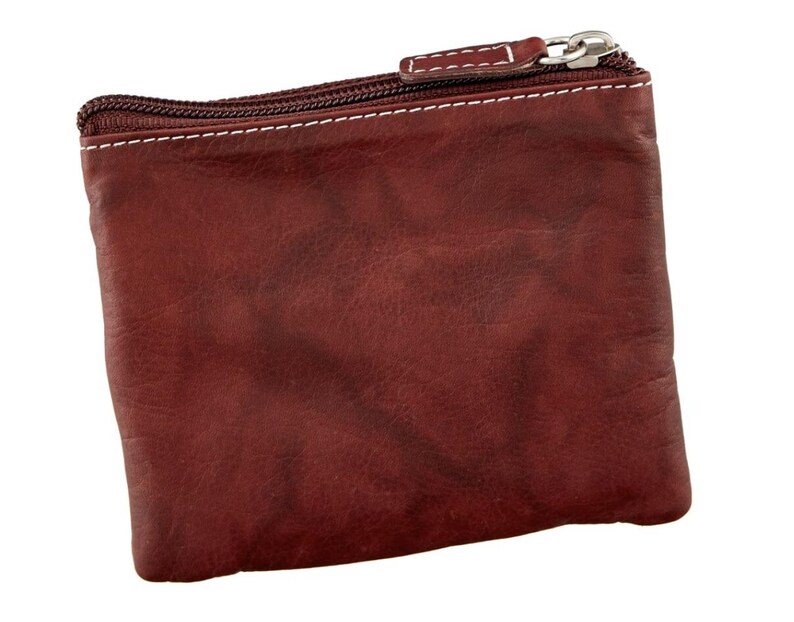 May include: A small, rectangular, burgundy leather coin purse with a silver zipper and white stitching. The purse has a textured surface and a simple, classic design. The zipper pull is also silver.