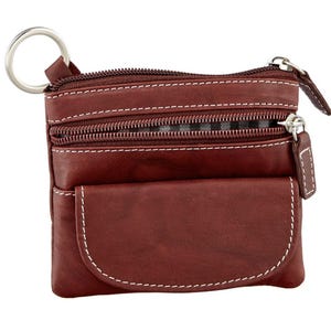 May include: A brown leather coin purse with white stitching and multiple zippered compartments. The purse has a key ring attached and a small front pocket. The zippers and key ring are silver-colored.