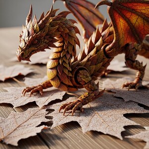 May include: A detailed, handcrafted dragon figurine with a leaf-like texture in shades of brown, orange, and yellow. The dragon has large wings and is posed on a wooden surface with scattered leaves. The figurine's intricate design is highlighted by the lighting.