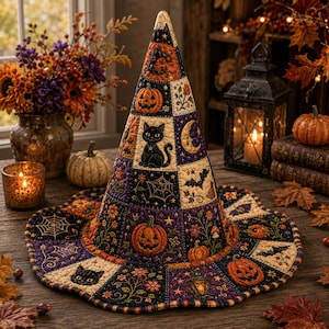 May include: A quilted fabric witch hat featuring a patchwork design with orange, purple, and black squares. The pattern includes illustrations of jack-o'-lanterns, black cats, crescent moons, spider webs, bats, and floral motifs throughout.