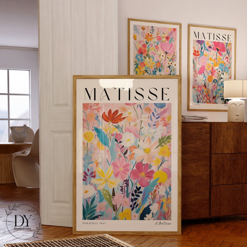 May include: Three framed art prints featuring colorful floral illustrations with the text "MATISSE" on each print. The largest print is a close-up of the flowers with the text "MARSEILLE 1905" and "H. Matisse" at the bottom.