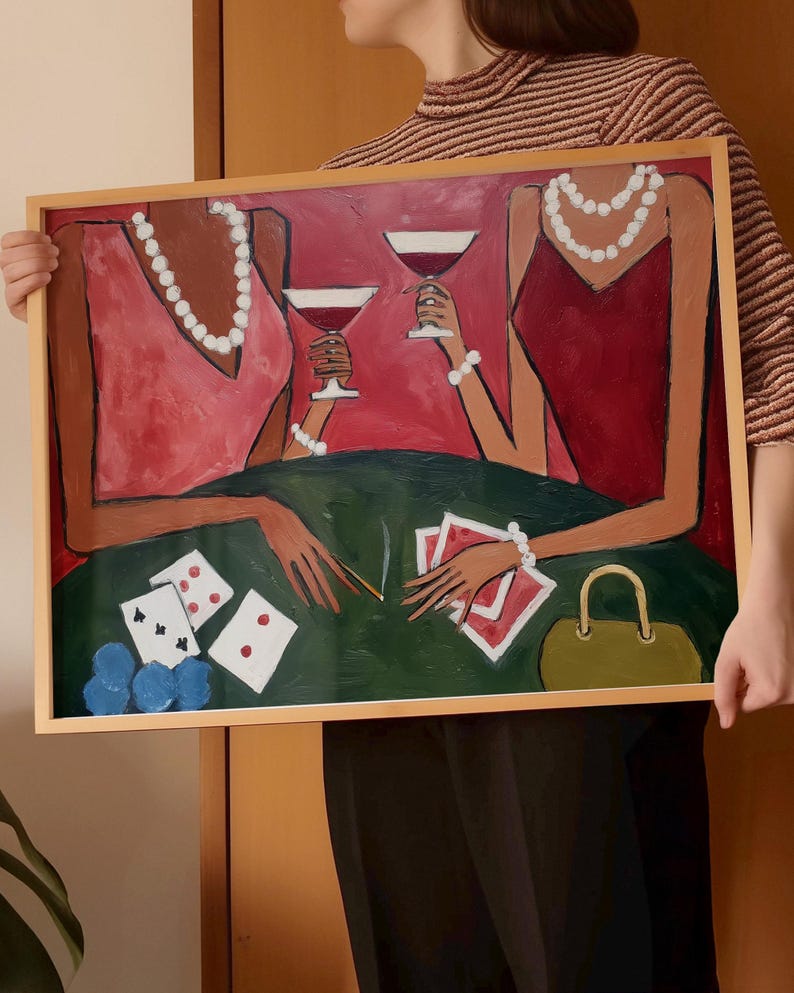 May include: An abstract painting in a wooden frame depicts two figures in red dresses, holding wine glasses. A green table displays playing cards, dice, and a purse. The figures wear pearl necklaces and bracelets. The background is red.