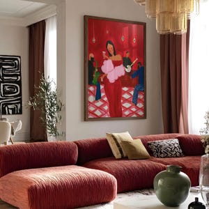 May include: A living room with a large red sofa and a framed painting. The painting depicts a woman in a red dress with a pink boa, with a band playing in the background. A green vase and decorative pillows are on the sofa.