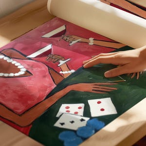 May include: A rolled-up canvas print featuring a painting of a poker game. The artwork depicts figures in red dresses, holding wine glasses, and playing cards on a green table. Blue poker chips are also visible.