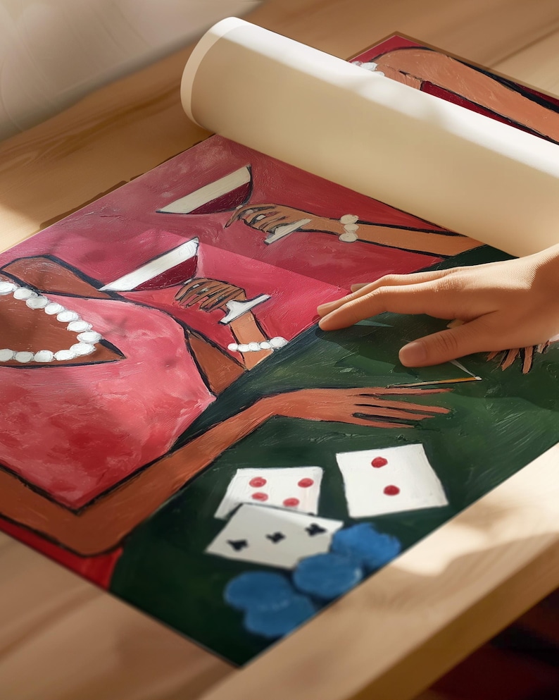 May include: A rolled-up canvas print featuring a painting of a poker game. The artwork depicts figures in red dresses, holding wine glasses, and playing cards on a green table. Blue poker chips are also visible.