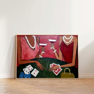 May include: An abstract painting depicts two figures at a table, holding wine glasses. The figures wear red and pink dresses and pearl necklaces. Poker chips and playing cards are on the green table. A small green purse is also visible.