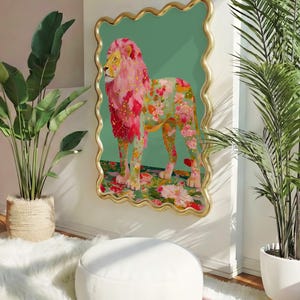 K&ouml;nnte beinhalten: Dekorative Wandkunst mit einem L&ouml;wen mit rosa M&auml;hne und floralem K&ouml;rper. Das Kunstwerk ist vor einem t&uuml;rkisgr&uuml;nen Hintergrund in einem goldfarbenen, wellenf&ouml;rmigen Rahmen angeordnet. Der Raum umfasst Topfpflanzen und einen wei&szlig;en Hocker.
