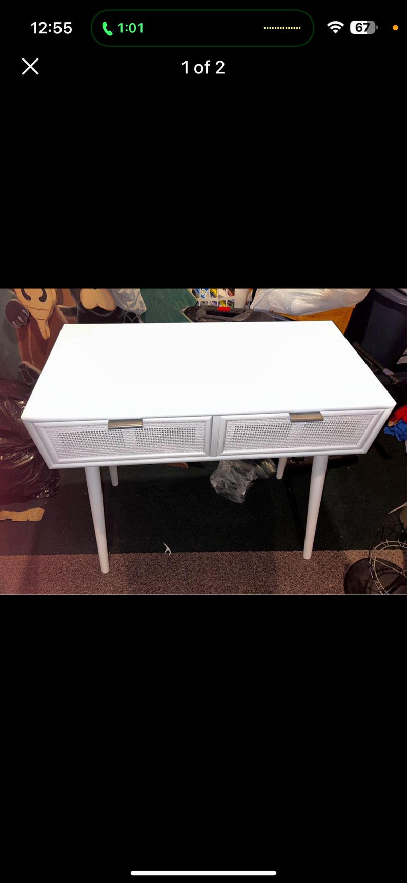 May include: White mid-century style desk with two drawers. The drawers have a woven cane design and brass-coloured handles. The desk has four tapered legs. The desk is approximately 120 cm long.