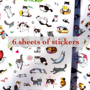 May include: Six sheets of stickers featuring various illustrations of cats in different poses and expressions. The stickers are on a white background with black outlines. The text on the stickers includes 