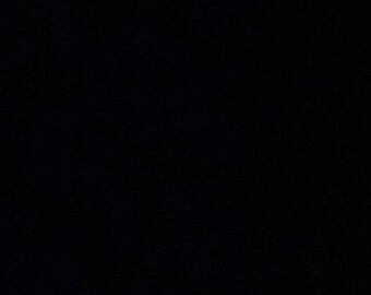 May include: A dark, nearly all-black image. The image is dominated by a black background with subtle, textured patterns. The overall impression is one of deep shadow and minimal detail.