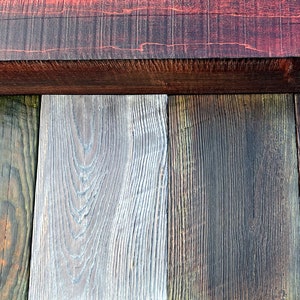 May include: Close-up of a wooden surface with five different wood planks, each with a unique color and grain pattern. The planks are arranged horizontally, with a darker wood plank at the top.