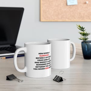 May include: Two white ceramic mugs with black text. The mug on the left has the text "NOW KINDLY CLUCK OFF, BEFORE I EXTRACT YOUR GIBLETS AND SHOVE A LARGE SEASONED ONION BETWEEN THE LIPS YOU NEVER KISS WITH".