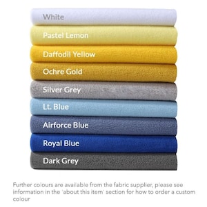 May include: A stack of fabric swatches in various colors, including white, pastel lemon, daffodil yellow, ochre gold, silver grey, light blue, airforce blue, royal blue, and dark grey. The text "Further colours are available from the fabric supplier, please see information in the 'about this item' section for how to order a custom colour" is at the bottom of the image.