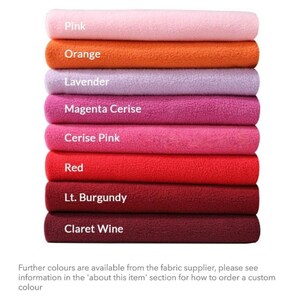 May include: A stack of eight fabric swatches in various shades of pink, red, and orange. The swatches are labeled with their color names: Pink, Orange, Lavender, Magenta Cerise, Cerise Pink, Red, Lt. Burgundy, and Claret Wine.