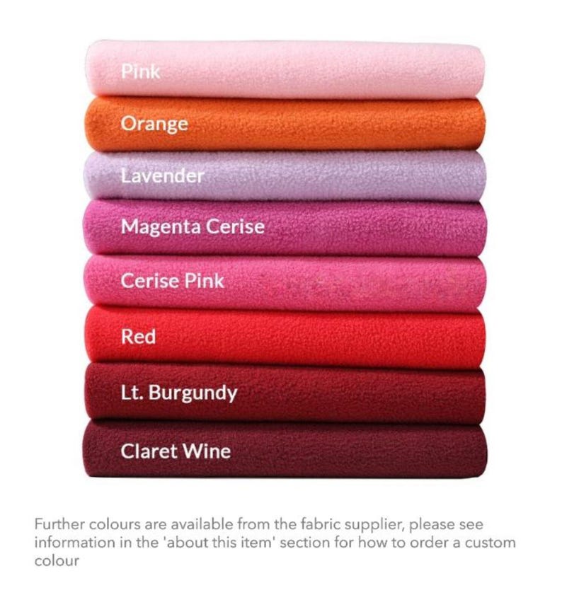 May include: A stack of eight fabric swatches in various shades of pink, red, and orange. The swatches are labeled with their color names: Pink, Orange, Lavender, Magenta Cerise, Cerise Pink, Red, Lt. Burgundy, and Claret Wine.