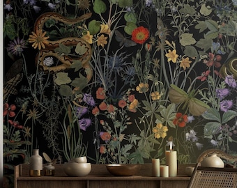 May include: A black and white botanical print wallpaper featuring snakes, butterflies, and flowers. The wallpaper is displayed in a room with a wooden console table and a wicker chair.
