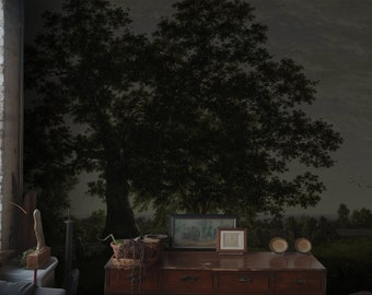 May include: A dark, moody painting of a forest scene with two large trees in the foreground. The painting is framed and hanging on a wall in a room with a wooden desk and other objects.
