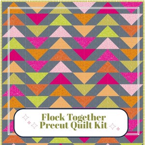 May include: A precut quilt kit with a geometric pattern of colorful triangles in shades of orange, pink, yellow, and green on a gray background. The text "Flock Together Precut Quilt Kit" is displayed in a white oval.