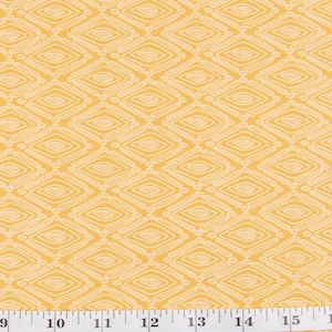 May include: Mustard yellow fabric featuring a repeating white diamond pattern. A white measuring tape is visible along the bottom edge, with the Pretty Cute Quilts logo below. The fabric is likely for quilting or crafting projects.