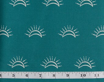 May include: Teal fabric with a white repeating pattern of stylized suns. The fabric is measured with a white ruler that reads "PRETTY CUTE QUILTS".