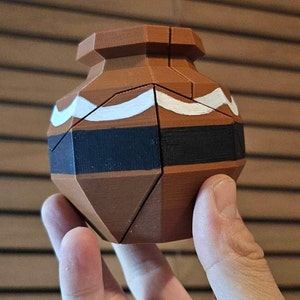 May include: A brown and black geometric puzzle in the shape of a pot with white accents. The puzzle is made of multiple pieces that fit together.
