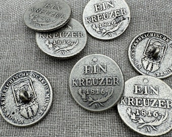 May include: Six silver-toned metal buttons with the inscription "Ein Kreuzer 1816" and a star. The buttons have a raised design of a wreath and a letter "A".