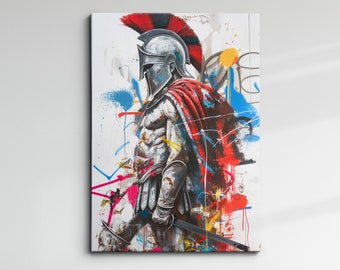 May include: Canvas art print of a Spartan warrior in full armor, holding a sword. The artwork features a red cape, a silver helmet with a red plume, and colorful paint splatters against a white background. The warrior is depicted in a side profile.