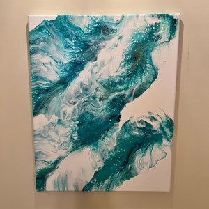 May include: Abstract painting on canvas with swirling white and teal blue paint. The paint has a marbled effect with white and teal blue colors.