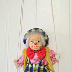 vintage doll, porcelain doll, clown doll hanging on a bench, clown doll, collectible doll, soft doll, hand painted face.