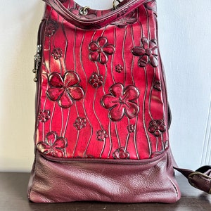 Vintage   BACKPACK PURSE leather burgundy leather pocket metal buckles , floral pattern.