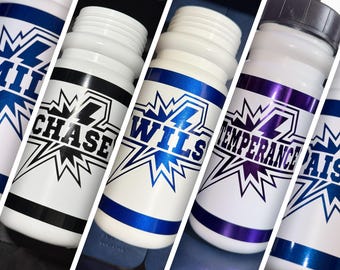 May include: A collection of white plastic water bottles featuring a comic book style graphic with a starburst design. Each bottle displays a unique name in bold lettering, including Chase, Wils, and Temperance, with colored accents in blue, black, and purple.