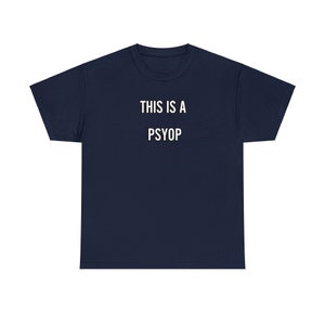 May include: A navy blue t-shirt with the text "THIS IS A PSYOP" printed in white.