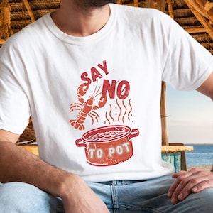 May include: White t-shirt with a red lobster illustration and the text "SAY NO TO POT" in a vintage style.